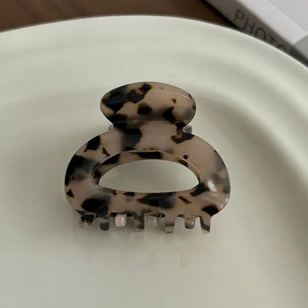 Detailbild des SOFT Leo Mini Haarclip von TREND Kollektiv arrangiert auf einer weißen Porzellanplatte